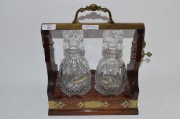 TANTALUS WITH TWO CUT GLASS DECANTERS AND SILVER PLATED LABELS WITH KEY