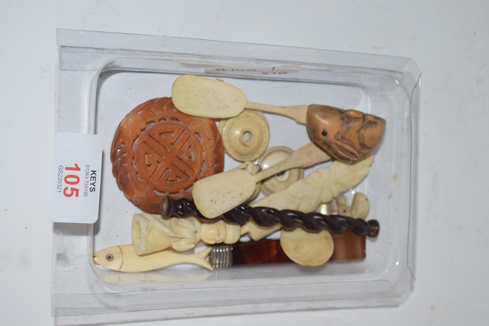 SMALL PLASTIC DISH CONTAINING BONE AND OTHER ITEMS INCLUDING A NETSUKE MODELLED AS A RABBIT