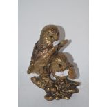 TWO GILT COLOURED OWLS ON BRANCH