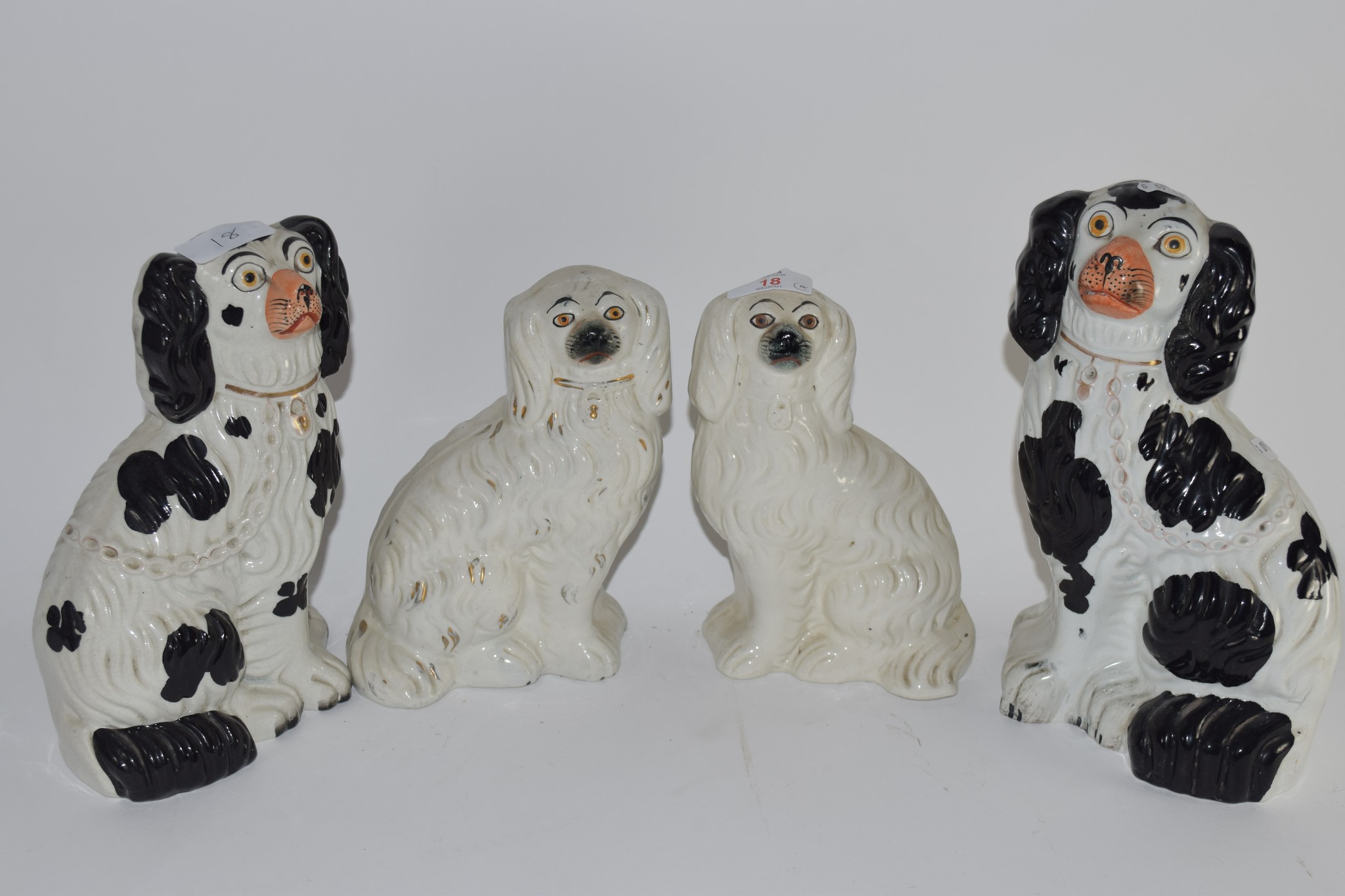 STAFFORDSHIRE DOGS, WITH BLACK SPONGED DECORATION AND FURTHER PAIR OF DOGS WITH WHITE AND GILT