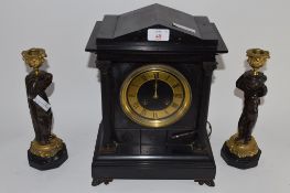 SLATE MANTEL CLOCK WITH GOLD DIAL AND TWO REEDED COLUMNS, TOGETHER WITH A PAIR OF CANDLESTICKS