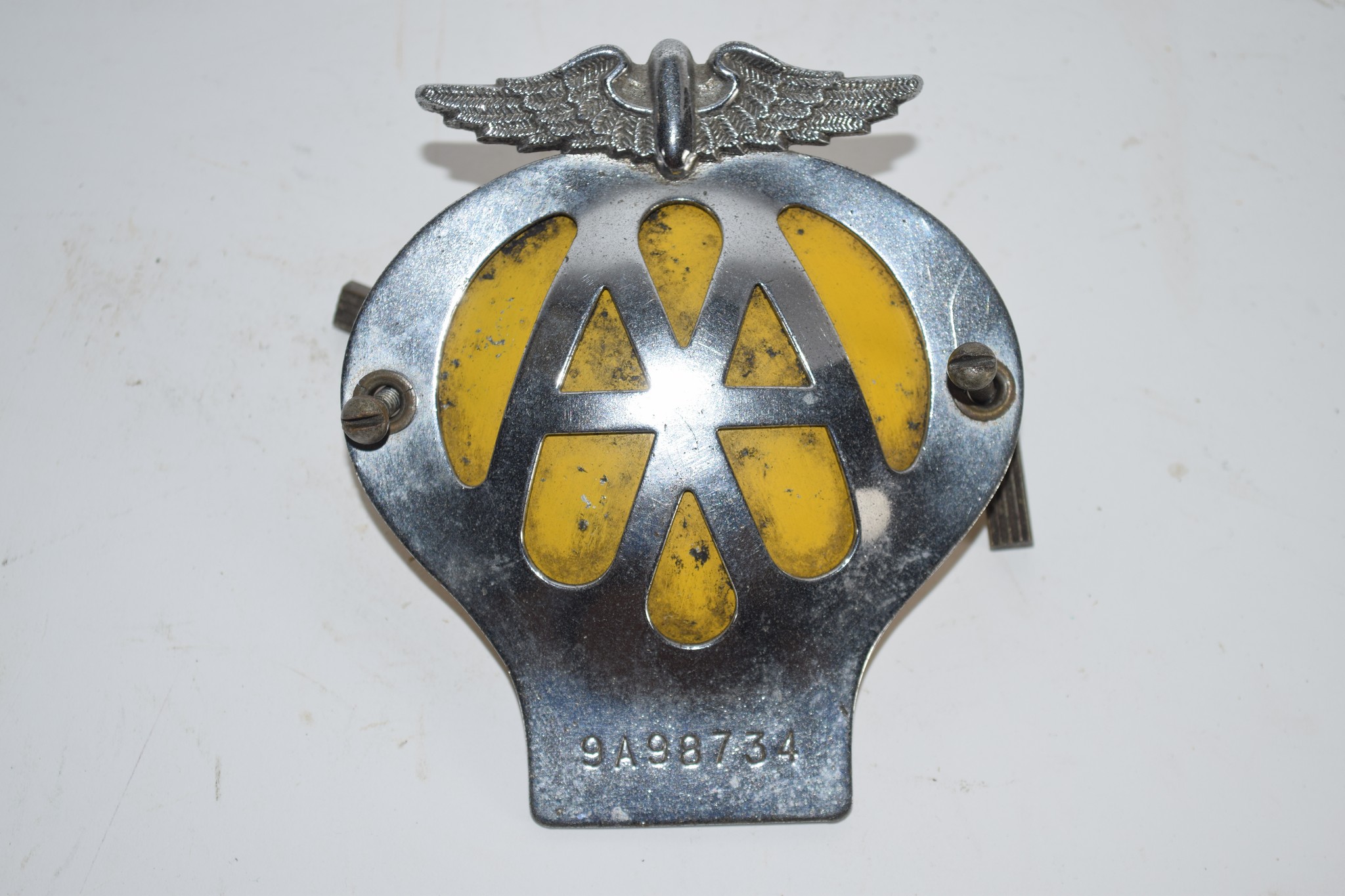 PLASTIC BAG CONTAINING AN AA BADGE