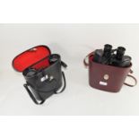 TWO BINOCULARS IN LEATHER CASES, ONE MADE BY UNIVERSAL 7X50 MAGNIFICATION, THE OTHER BY CONCORD WITH