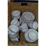 BASKET CONTAINING PART POLISH CERAMIC TEA SET WITH WHITE AND FLORAL DESIGN