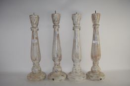 FOUR WHITE GLAZED WOODEN CANDLEHOLDERS