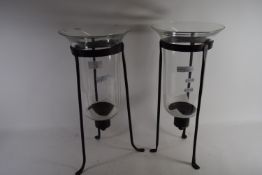 CANDLEHOLDERS WITH GLASS SHADE RAISED ON THREE METAL FEET