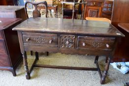 DARK WOOD LOW DRESSER IN THE ARTS AND CRAFTS STYLE, RAISED ON TURNED JOINTED LEGS, THREE CARVED
