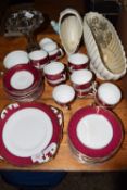 TEA SET WITH A GILT DESIGN ON PINK GROUND COMPRISING 10 CUPS, SAUCERS ETC AND SOME SMALL GLASS