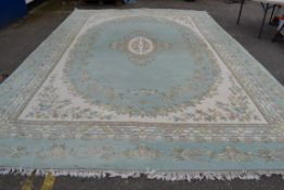 VERY LARGE PREDOMINANTLY GREEN AND CREAM GROUND RUG, SIZE APPROX 560 X 360CM