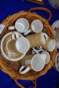 WICKER BASKET CONTAINING CINQUE PORTS RYE POTTERY MUGS AND SAUCERS