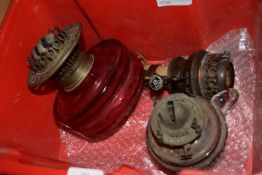 BOX CONTAINING OIL LAMP ACCESSORIES INCLUDING RED GLASS RESERVOIR WITH MOUNTS ETC