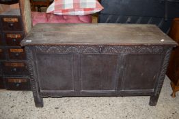 18TH/19TH CENTURY OAK COFFER RAISED ON STILE FEET OF TYPICAL PANELLED CONSTRUCTION, WITH CARVED