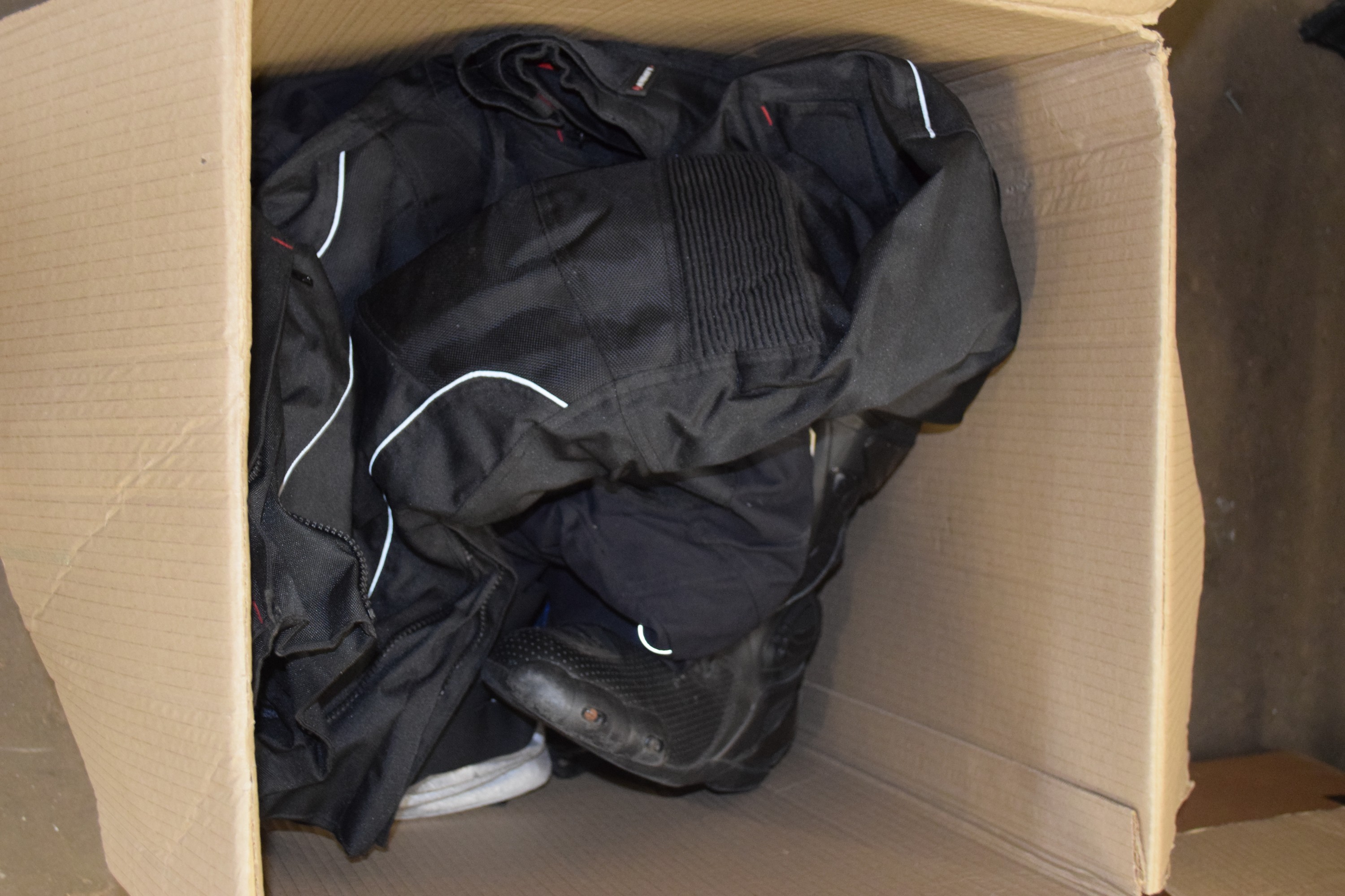 BOX CONTAINING MOTORCYCLE TROUSERS AND SHOES, TWO BICYCLE HELMETS
