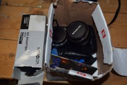 SMALL BOX CONTAINING A 28-48MM OLYMPUS LENS, A FURTHER 50MM OLYMPUS LENS, INSTRUCTION MANUALS AND