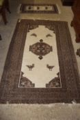 PATTERNED RUG AROUND CENTRAL PANEL CONTAINING STYLISED BIRDS ETC, APPROX 133 X 212CM