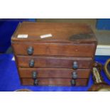 SMALL WOODEN CHEST OF DRAWERS CONTAINING BEADS AND WRIST WATCH