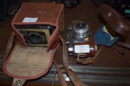 TWO VINTAGE CAMERAS: A CASED BROWNIE 6-20 MODEL D BY KODAK AND A CASED EXAMPLE