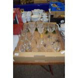 TRAY CONTAINING GLASS WARES INCLUDING SET OF ENGRAVED WINE GLASSES WITH GREEN STEMS