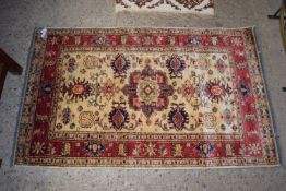 RUG WITH STYLISED FLORAL AND LEAF DESIGNS AROUND GEOMETRIC CENTRAL PANEL, APPROX 90CM X 150CM