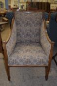 EDWARDIAN UPHOLSTERED BERGERE CHAIR RAISED ON TAPERED LEGS, WITH STRUNG DECORATION, WIDTH APPROX