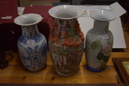 THREE ORIENTAL VASES, ONE WITH POLYCHROME DECORATION AND OTHERS WITH BLUE AND WHITE