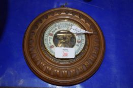 SMALL BAROMETER IN CIRCULAR WOODEN FRAME