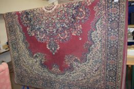 LARGE PREDOMINANTLY RED AND CREAM GROUND CARPET, 187CM WIDE