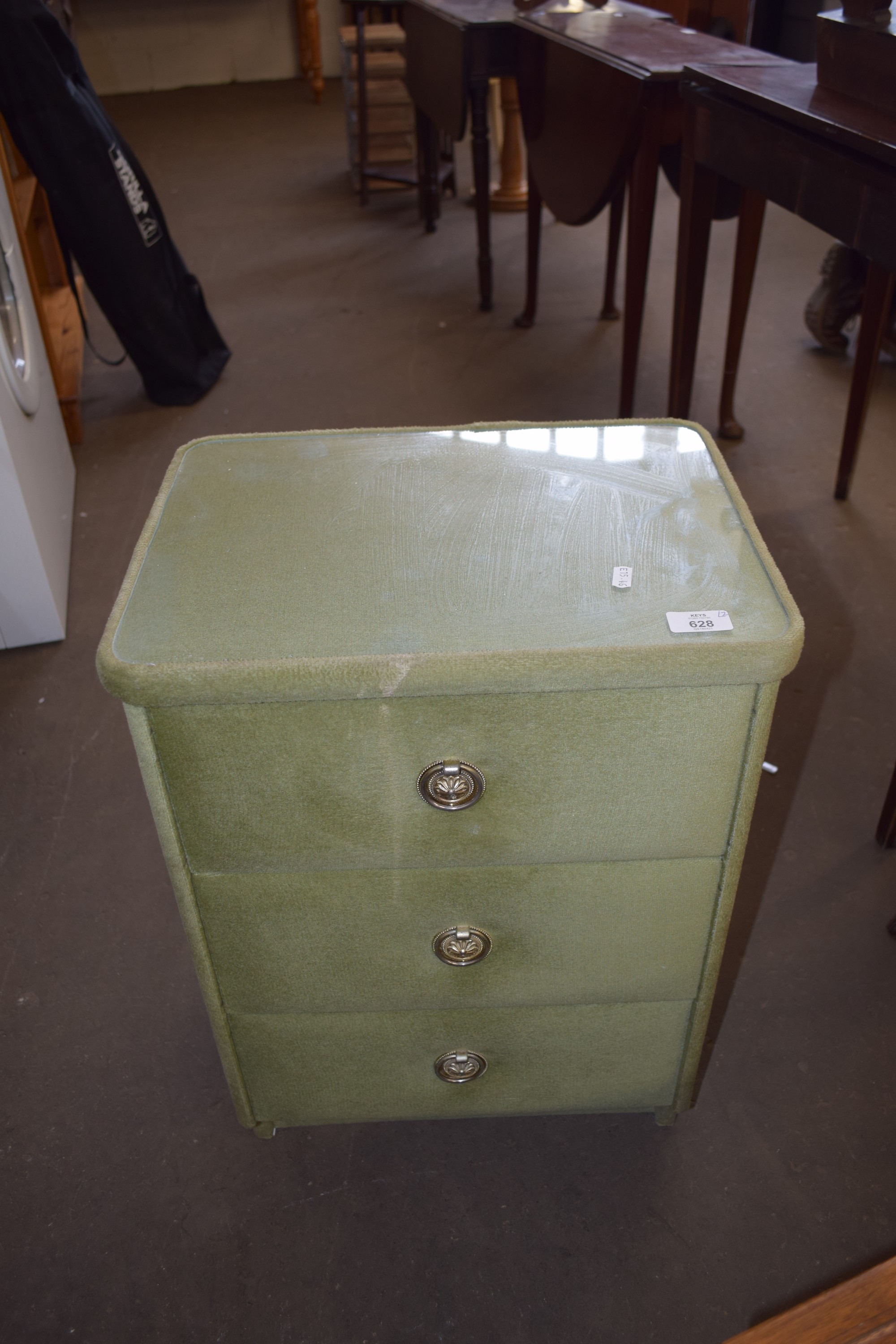 PAIR OF GREEN PLUSH UPHOLSTERED GLASS TOPPED BEDSIDE CABINETS WITH RING HANDLES, 62CM HIGH