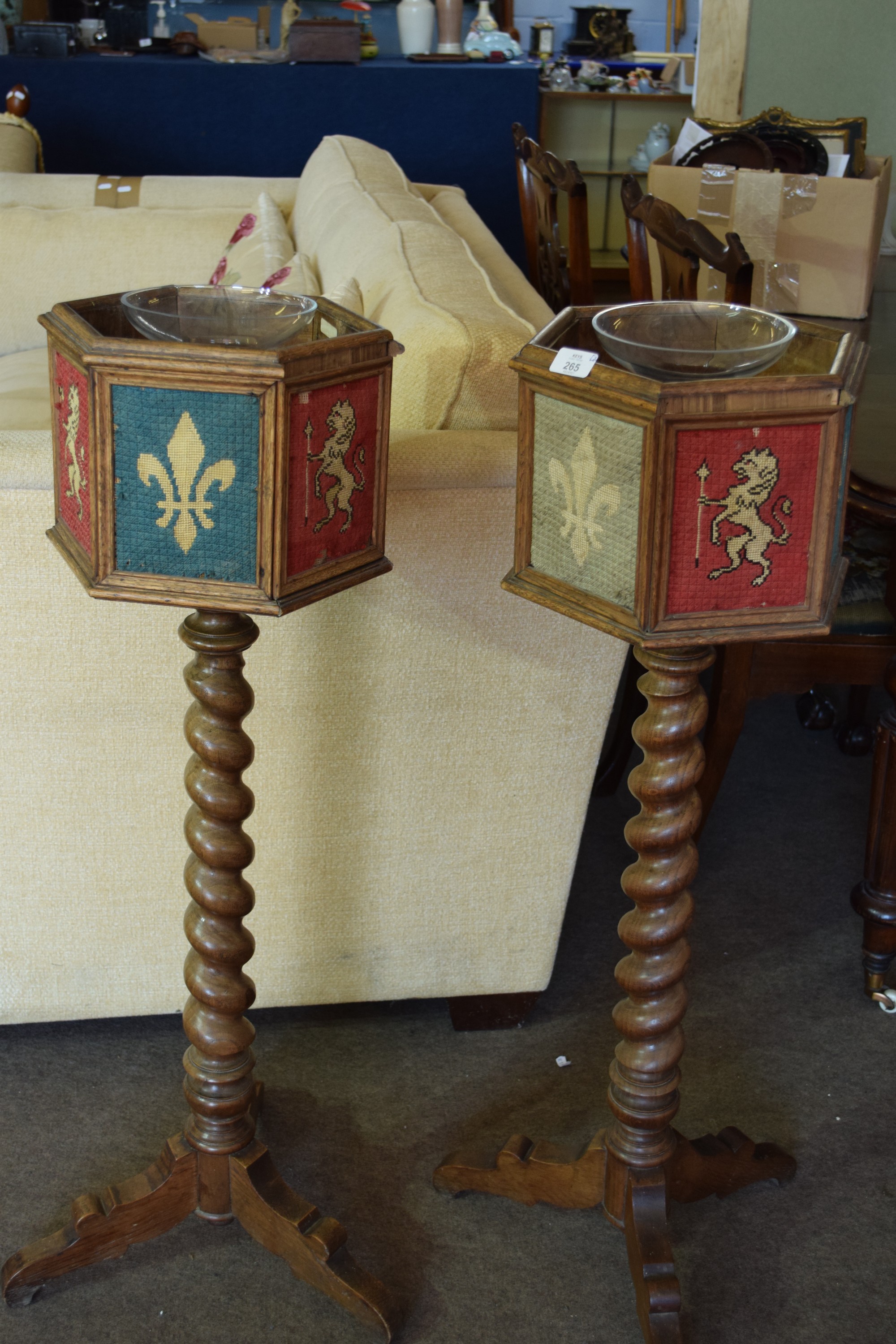 Pair of hexagonal plant stands raised on barley twist turned wood columns with woven heraldic