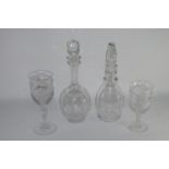 Two decanters, one with an air twist knop, the other with an engraved floral design, together with