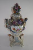 Large Continental porcelain vase with floral encrusted decoration, the reticulated cover with a