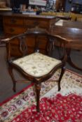 Finely carved upholstered corner chair, width approx 63cm