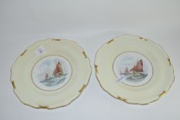 Pair of Royal Crown Derby plates, the centres painted with yachts by W E J Dean, factory marks to