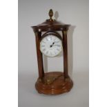 Quartz clock in wooden case, supported by four wooden pillars, with brass acorn knop, 27cm high