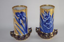 Pair of Royal Doulton vases decorated in blue with irises above a gilt design on blue ground,