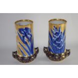 Pair of Royal Doulton vases decorated in blue with irises above a gilt design on blue ground,