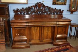 Large ornately carved 19th century mahogany sideboard, the central cupboard flanked by two