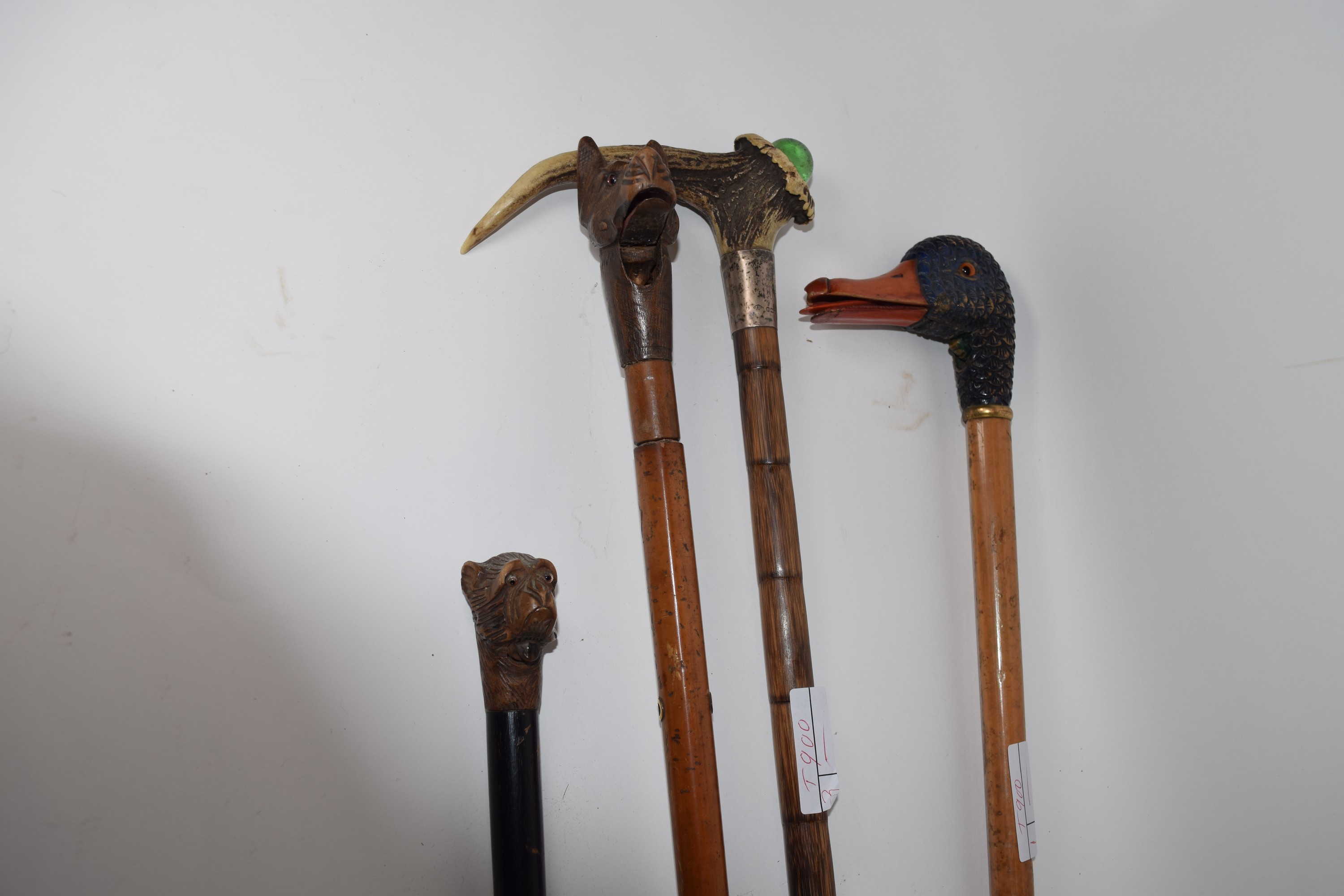 Group of walking canes modelled with various heads, including a duck's head with glass eyes, a - Image 2 of 2
