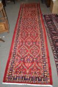 Large red ground Persian Kashan Runner, with all-over floral pattern 397cm x 93cm approximately