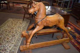 Good quality carved pine rocking horse with stretcher base, width 133cm x 57cm deep x 110cm high (