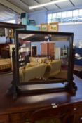 19th century stained oak swing mirror, raised on cruciform stand, width approx 90cm max