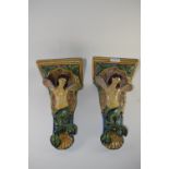 Two late 19th century Continental Majolica wall pockets decorated in typical glazes with mermaids,