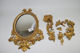 Wall mirror in oval gilt frame (some parts of wooden frame detached but present)