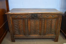 Oak coffer with three panel front and plain interior on stile feet 109cm wide