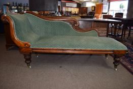 Mid to late 19th century mahogany upholstered chaise longue, raised on turned feet fitted with brass