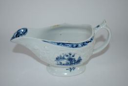 Small Lowestoft sauce boat, the body crisply moulded with flowers decorated in underglaze blue