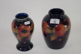 Two Moorcroft vases, both decorated with the pomegranate pattern, with factory marks and blue