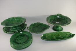 Quantity of green glazed dinner wares in Wedgwood style with fruit and leaf decoration in relief,