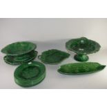 Quantity of green glazed dinner wares in Wedgwood style with fruit and leaf decoration in relief,