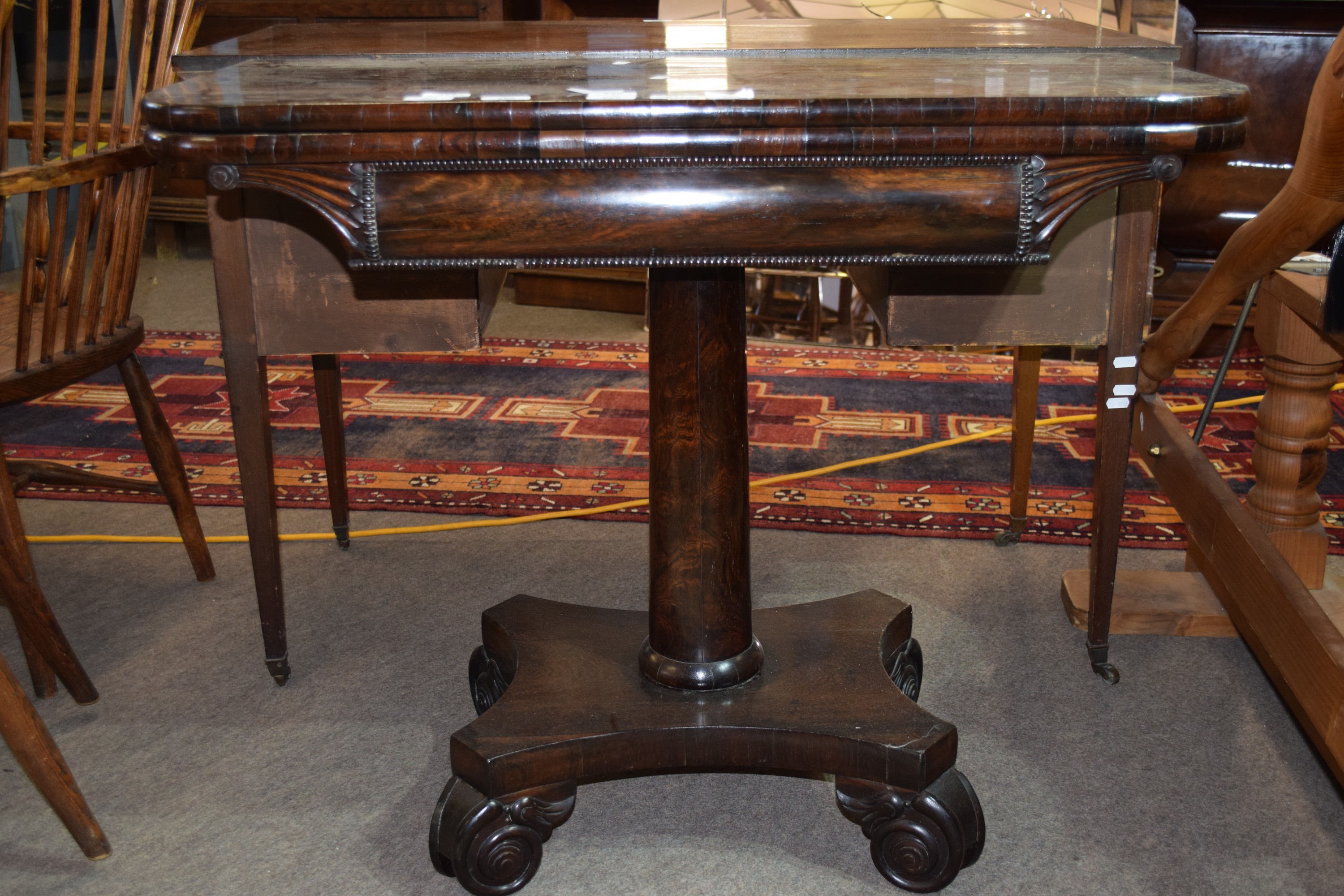 Early 19th century rosewood fold-top tea table, cylindrical column and quadruped base, 92.5cm wide
